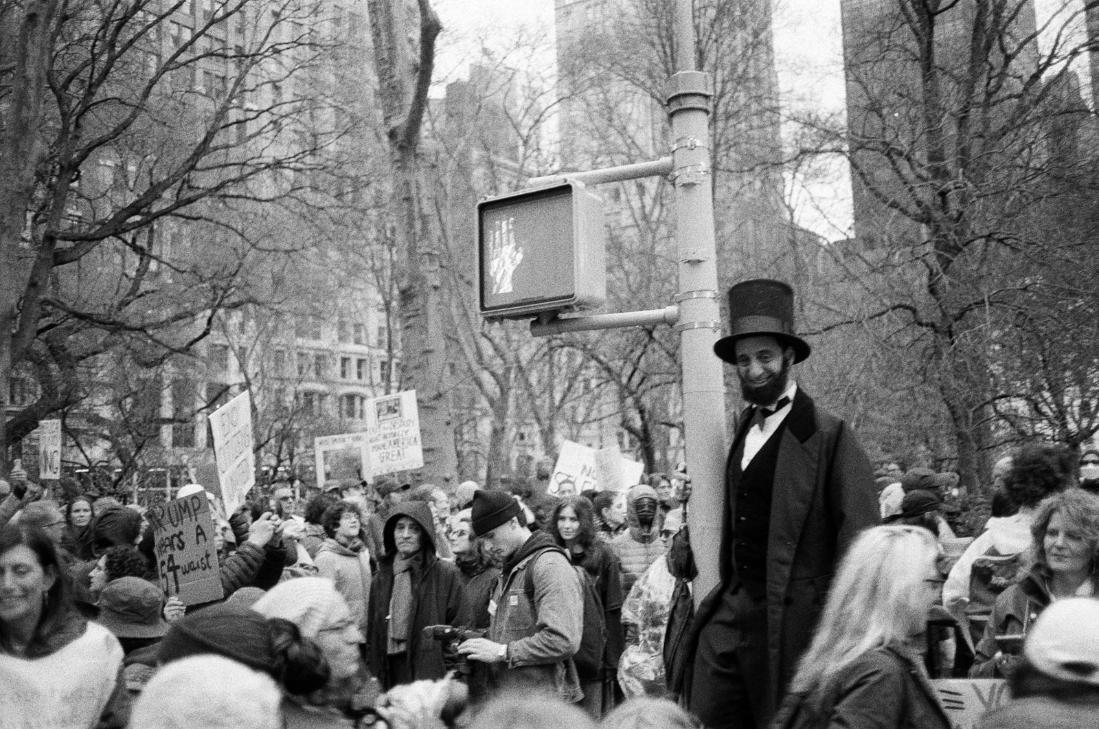 Man dressed as Abraham Lincoln in a crowd near Madison Square, black-and-white street photograph, New York
